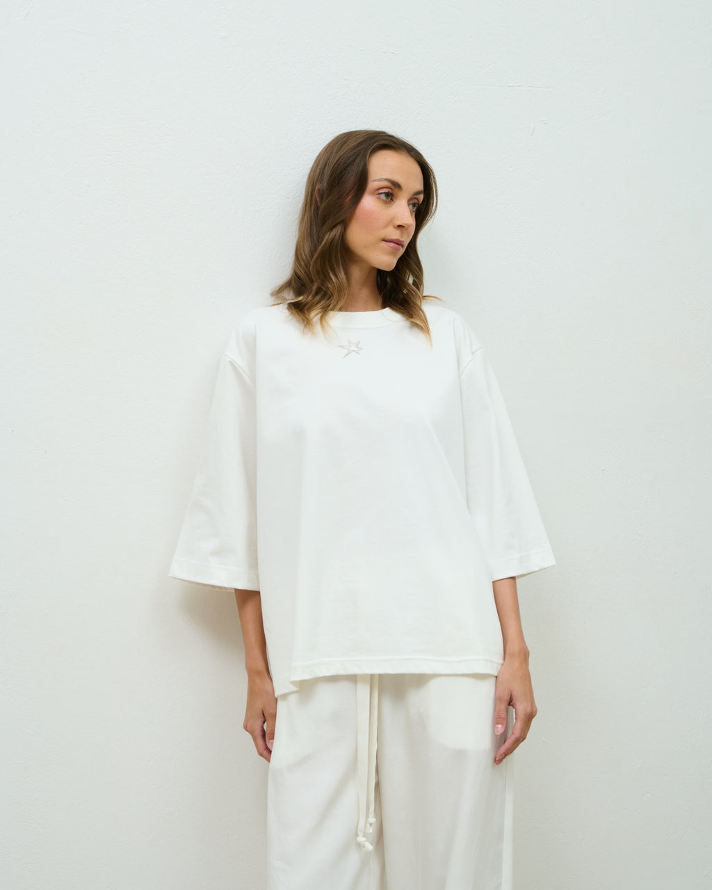 Model wearing the off-white oversized Star Tee with the embroidered star detail
