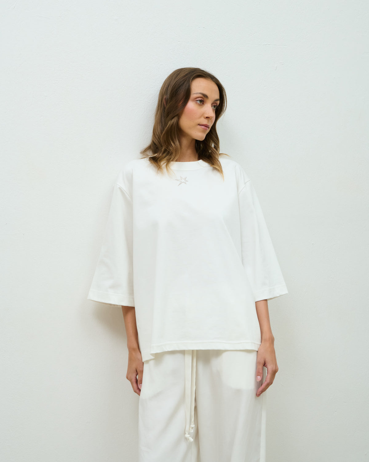 Model wearing the off-white oversized Star Tee with the embroidered star detail