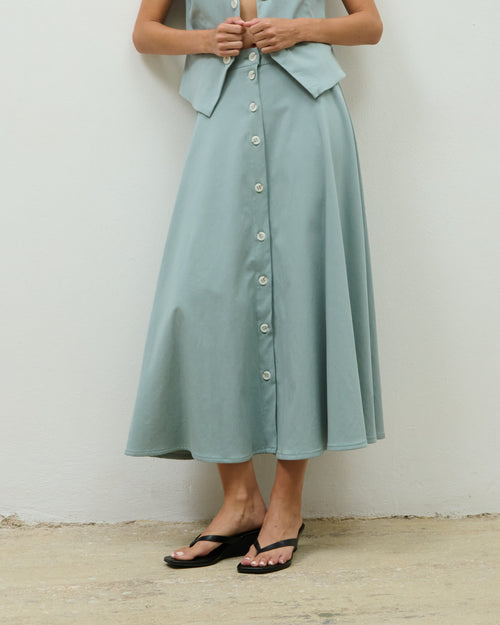 Close-up of the sage green Helena Skirt, A-line silhouette with front buttons